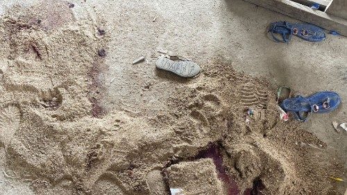 Sand covers a puddle of blood at an empty clasroom following a shooting at a school in Kumba, ...