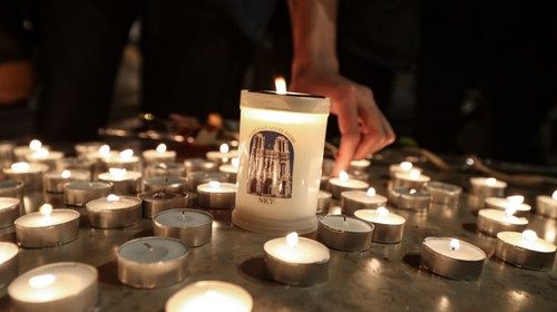 People lights candle outside the Notre-Dame de l'Assomption Basilica in Nice on October 29, 2020 in ...
