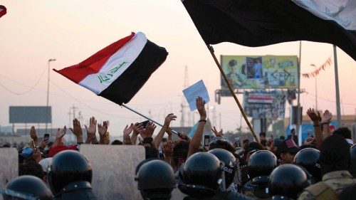 Iraqi anti-government protesters confront security forces as the latter attempt to break up a ...