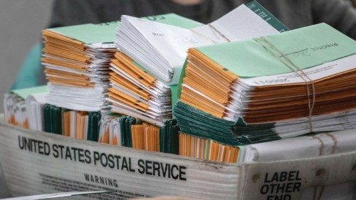 LANSING, MICHIGAN - NOVEMBER 02: Election workers sort absentee ballot envelopes at the Lansing City ...
