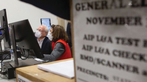 ATLANTA, GA - NOVEMBER 04: Members of an adjudication review panel look over scanned absentee ... ATLANTA, GA - NOVEMBER 04: Members of an adjudication review panel look over scanned absentee ...