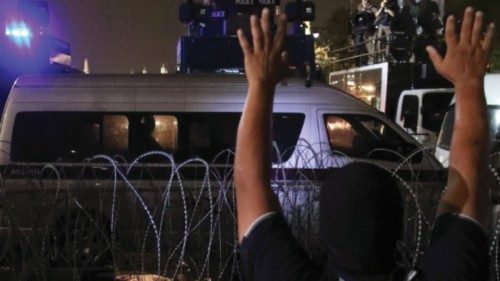 A demonstrator gestures towards police, during a rally to call for the ouster of Prime Minister ...