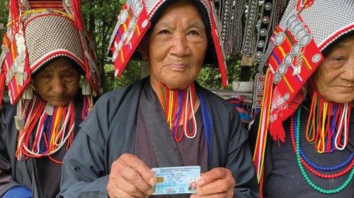 Ethnic Akha women, once regarded as stateless, holding their Thai citizenship identity cards in ...
