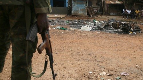 epa08816354 A military stand in front of a torched motorbike after the post-election intercommunal ...