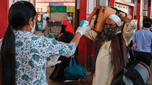 A health worker checks the body temperature of a passenger during Covid-19 coronavirus screening ... A health worker checks the body temperature of a passenger during Covid-19 coronavirus screening ...