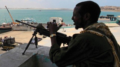 FILE PHOTO: A soldier from Somalia's Ras-Kamboni paramilitary group stands guard as he monitors ...