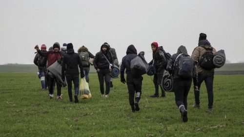Migrants walk on a field in an attempt to cross the Serbia, Hungary and Romania border near the ...
