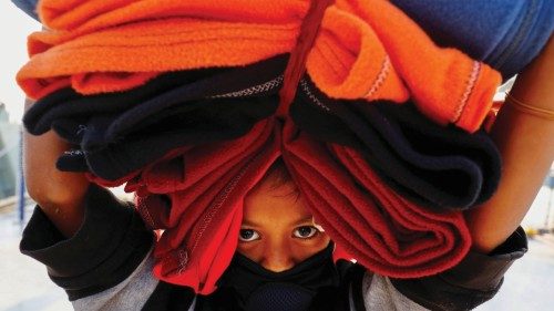 A Rohingya girl carries blankets as she prepares to board a ship to move to Bhasan Char island near ...