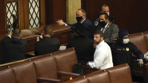 WASHINGTON, DC - JANUARY 06: U.S. Capitol police officers point their guns at a door that was ...