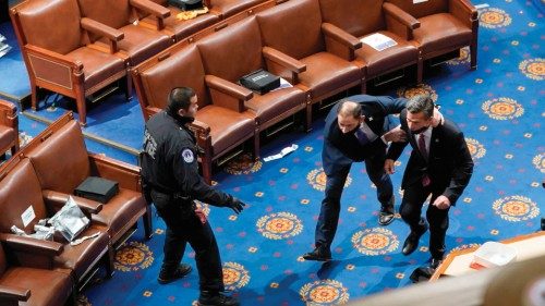 TOPSHOT - WASHINGTON, DC - JANUARY 06: Members of congress run for cover as protesters try to enter ...