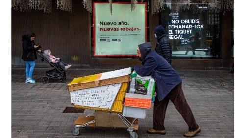 epa08924653 A homeless walks past a clothing shop in the first day of winter sales season in ...