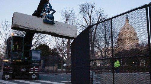 epa08925409 Barricades are placed behind new fencing at the West Front of the US Capitol the day ...