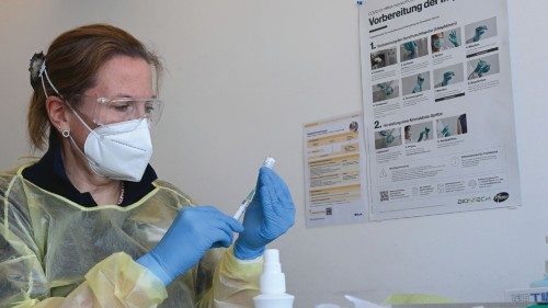 Tatjana Lang fills a syringe with the Pfizer-BioNTech COVID-19 vaccine against the novel coronavirus ...