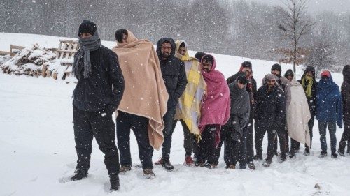 Migrants queue to receive food as hundreds of them are taking shelter in abandoned buildings in the ...