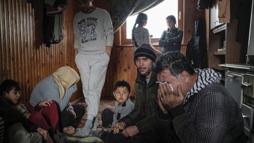 Husein Halaf Jabar, a migrant from Iraq, cries in front of his family as they live along with ...