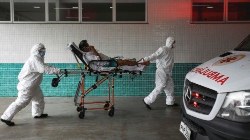 Health workers transport Joao Oliveira, 77, who, according to his wife, is suffering with COVID-19 ...
