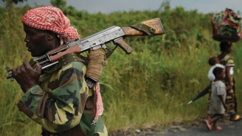 An M23 rebel marches towards the town of Sake, 26km west of Goma, as thousands of residents flee ...