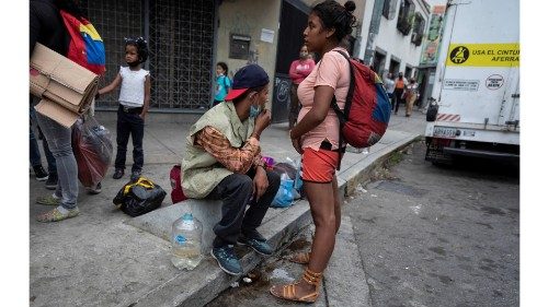 epa08933237 A group of people waiting for donations, in Caracas Venezuela, 06 January 2021 (issued ...