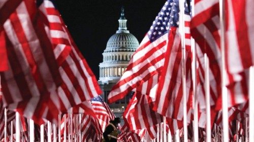 epa08947560 A person walks through the public art display 'Field of Flags', made up of over 200,000 ...