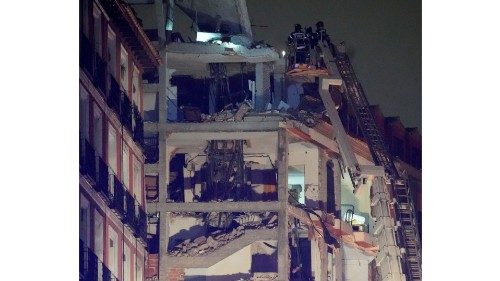 Firefighters work after a deadly explosion at a building belonging to the Catholic Church in Madrid ...