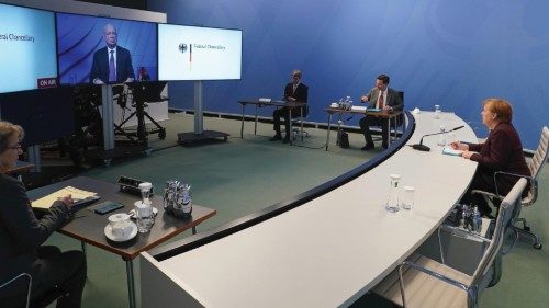 epa08966355 German Chancellor Angela Merkel (R) prepares to speak in a virtual dialogue meeting of ...