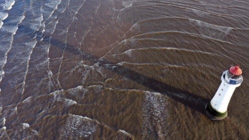 The tide moves around the New Brighton lighthouse in New Brighton, north west England on January 22, ...