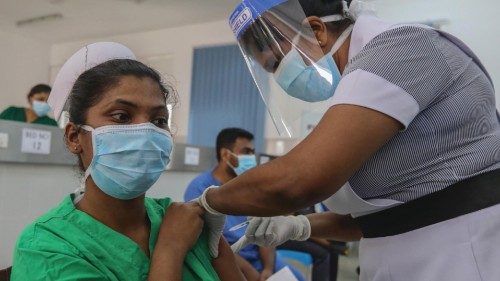 epa08972427 Sri Lankan frontline health workers get the first dose of a Oxford-AstraZeneca COVID-19 ...