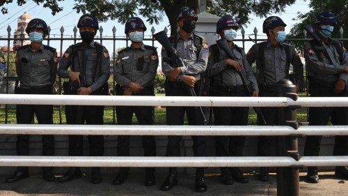 Police stand guard on a street in Yangon on February 4, 2021, days after a military coup. (Photo by ...