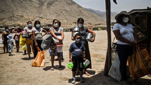 TOPSHOT - People keep safety distance as they wait to receive food at soup kitchen in Comas, in the ...