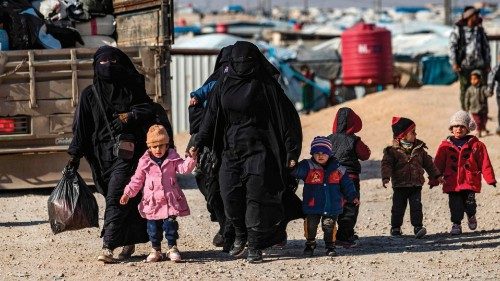 Women lead children ahead of departure during the release of another group of Syrian families from ...