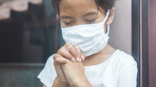 Asian child girl wearing protection mask praying for a new day freedom to coronavirus Covid-19 and ...