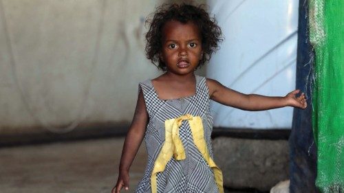 A girl looks on inside a school building for displaced Yemenis who fled fighting between Huthi ...
