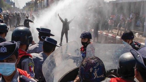 TOPSHOT - Police use a water cannon against protesters holding a demonstration against the military ...