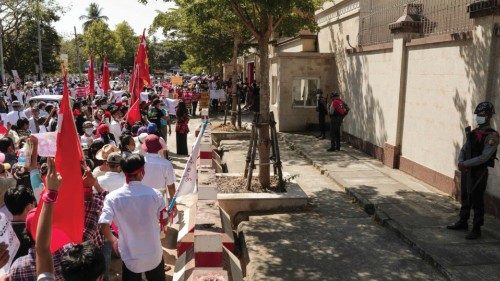 Protesters hold National League for Democracy (NLD) party flags as they take part in a demonstration ...