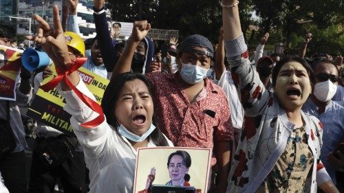 epa09013737 Demonstrators shout slogans during an anti-coup protest near the National League for ...