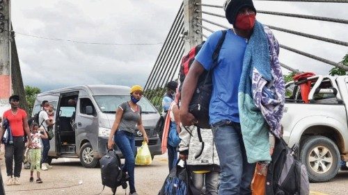 epa09018985 Haitian migrants cross the border in the De la Amistad bridge sector from Brazil, ...