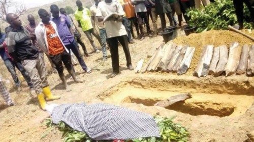 People attend the burial of Monday Doma, a student that was killed after gunmen stormed a Government ... People attend the burial of Monday Doma, a student that was killed after gunmen stormed a Government ...