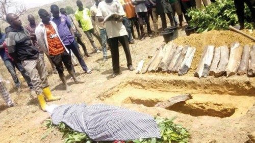 People attend the burial of Monday Doma, a student that was killed after gunmen stormed a Government ...