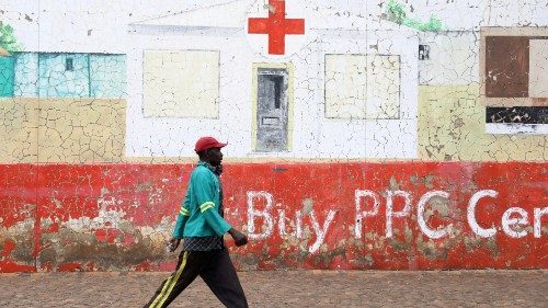 FILE PHOTO: A man, not wearing a face mask, walks beneath a mural depicting a hospital, amid the ...