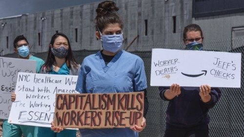 (FILES) In this file photo people protest working conditions outside of an Amazon warehouse ...