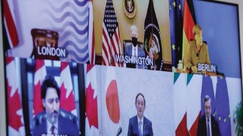 epa09023925 Heads of G7 states and governments appear on the screen as European Commission President ...