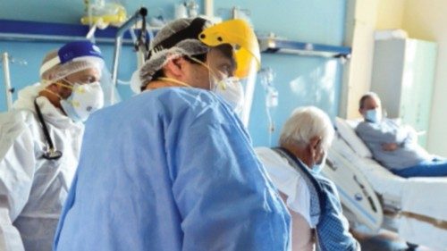 Doctor Francesco Tursi (L) along with colleague treat a patient suffering with the coronavirus ...