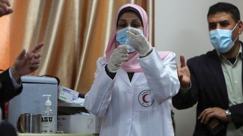 A Palestinian health worker prepares a coronavirus disease (COVID-19) vaccine in Gaza City February ...