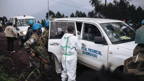 A medical vehicle of the North Kivu hospital is loaded with the body of the driver on a road on the ...