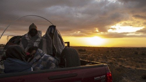 Venezuelan migrant Rubi Alexander G. (R) and friends travel in the back of a truck along Route 15, ...