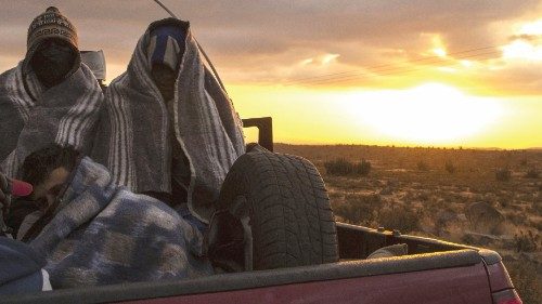 Venezuelan migrant Rubi Alexander G. (R) and friends travel in the back of a truck along Route 15, ...