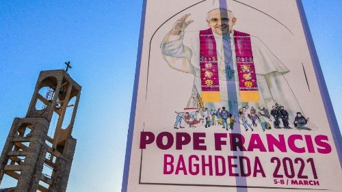 A sign welcoming Pope Francis hangs outside the Syriac Catholic Church of Mar Thoma (St Thomas), in ...