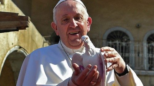 A handout picture released by the Vatican media office, shows Pope Francis holding a white dove at a ...