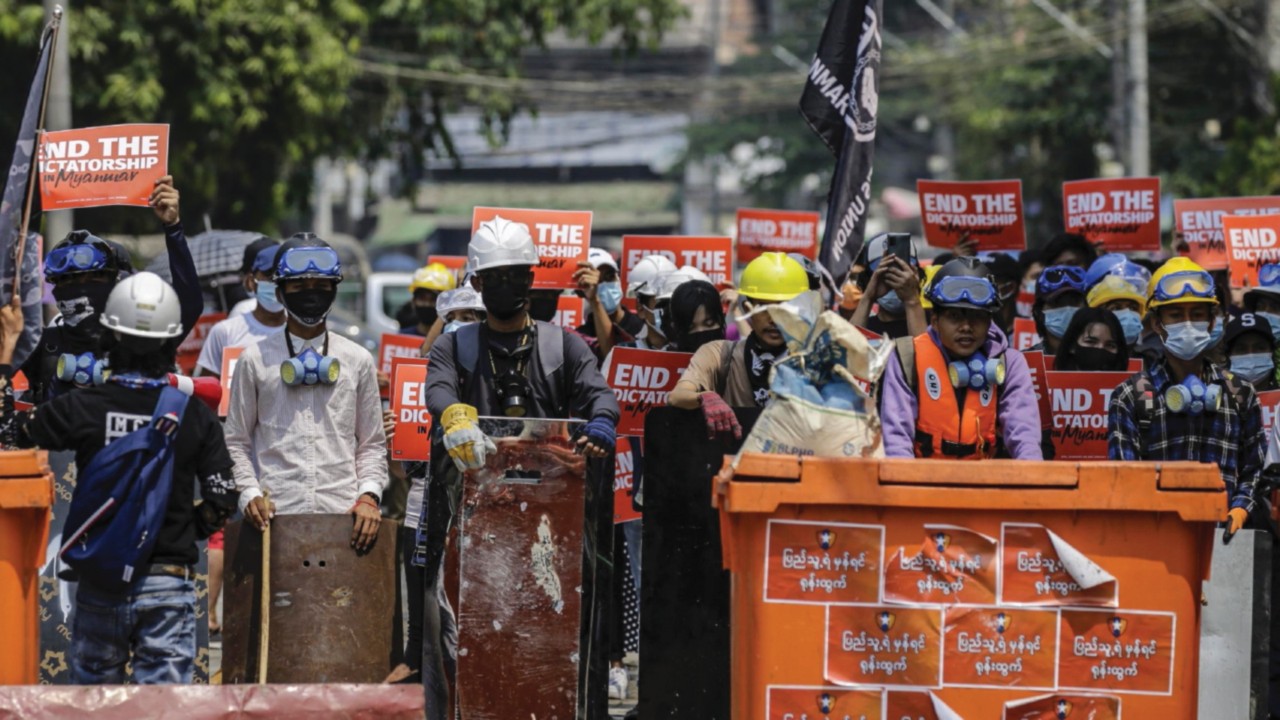 epa09069163 Demonstrators hold placards during a protest against the military coup, in Yangon, ...