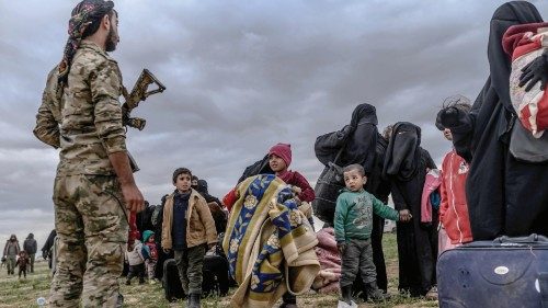 (FILES) In this file photo taken on February 27, 2019, young children look at a member of the ... (FILES) In this file photo taken on February 27, 2019, young children look at a member of the ...
